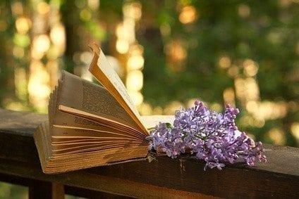book of poetry and lilac branch